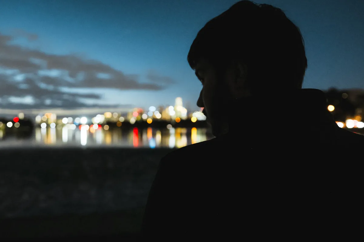 Gabe in silhouette against the Melbourne skyline at dusk