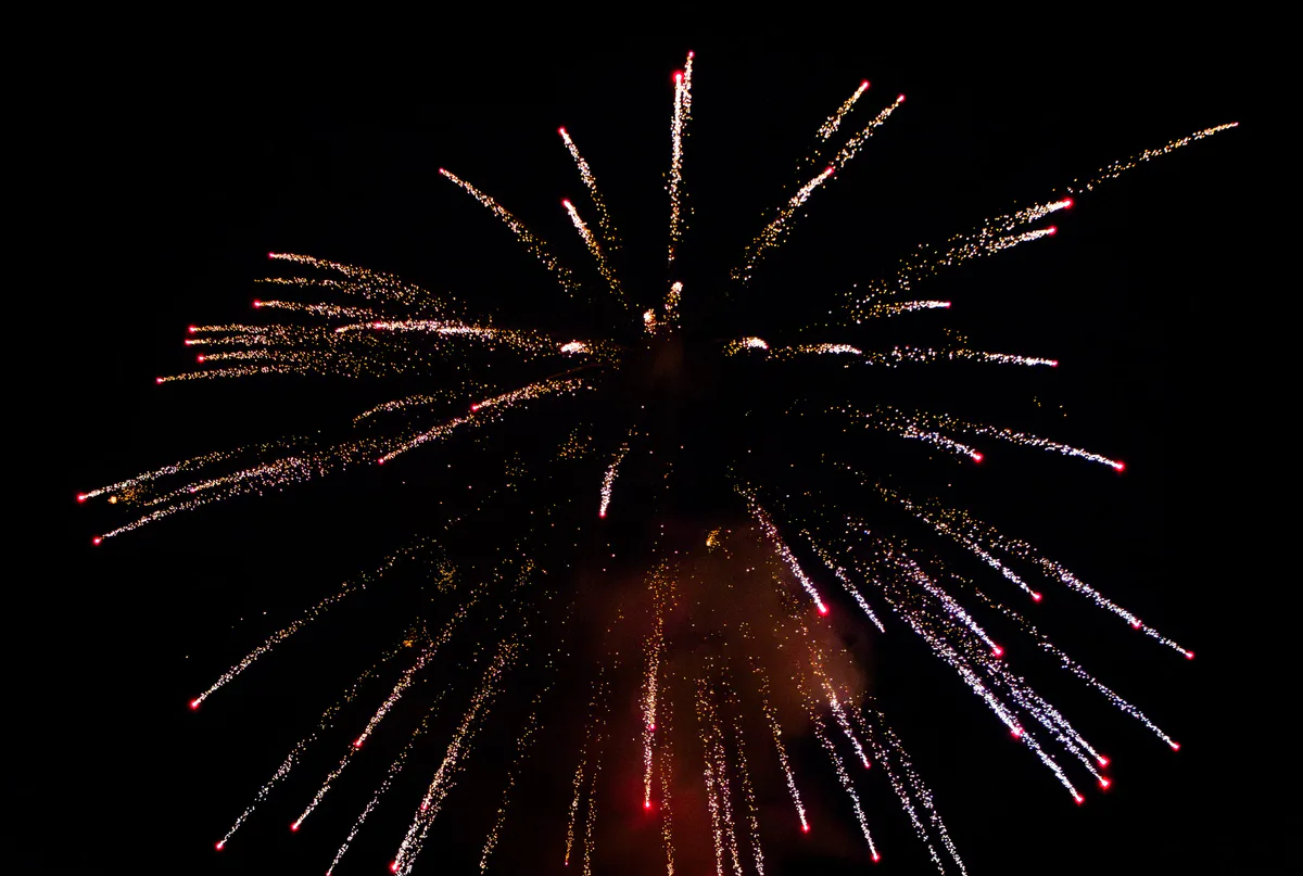 A gold burst with red glowing at its base.