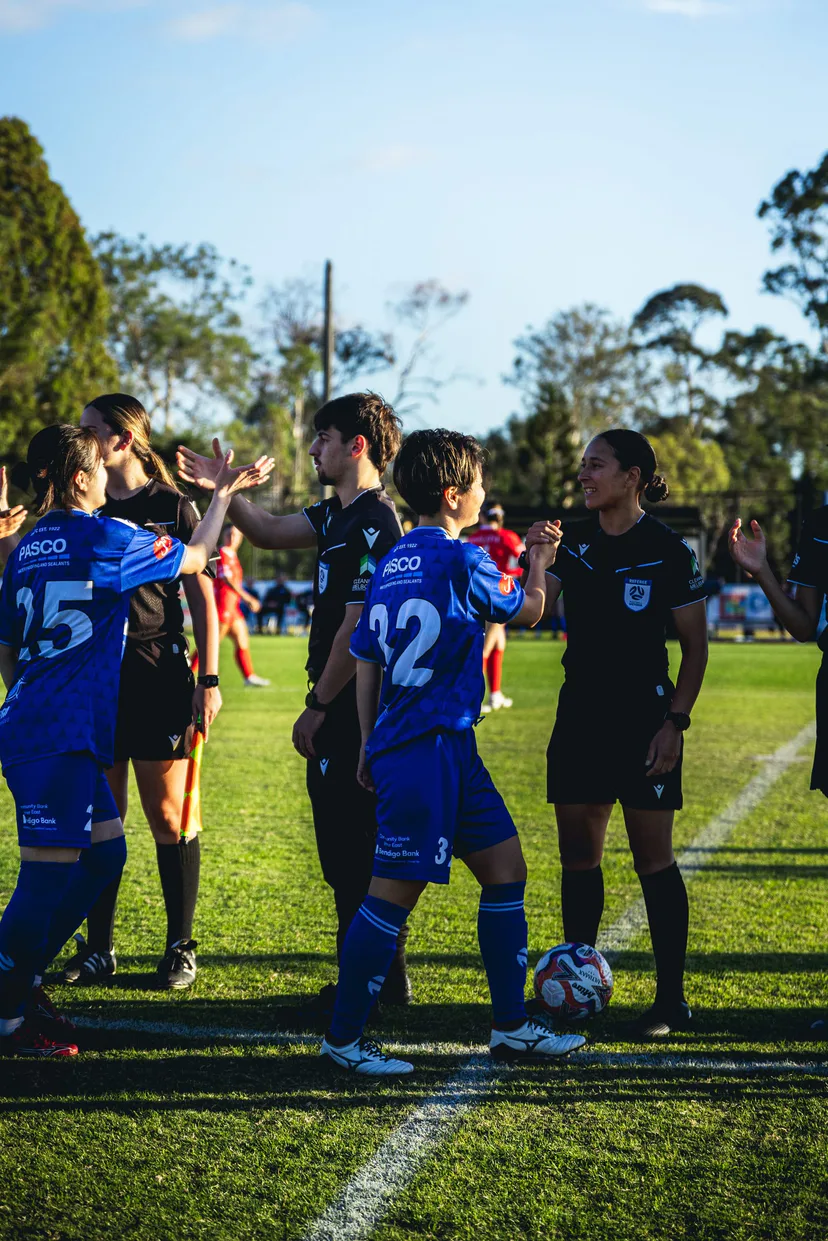 Box Hill United players shaking hands with the match officials before kick-off