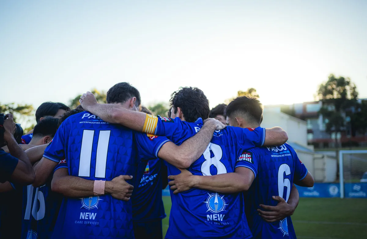 The Box Hill United side in a huddle before kick-off