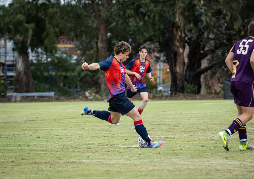 Brighton Grammar First XI player striking the ball in a soccer match
