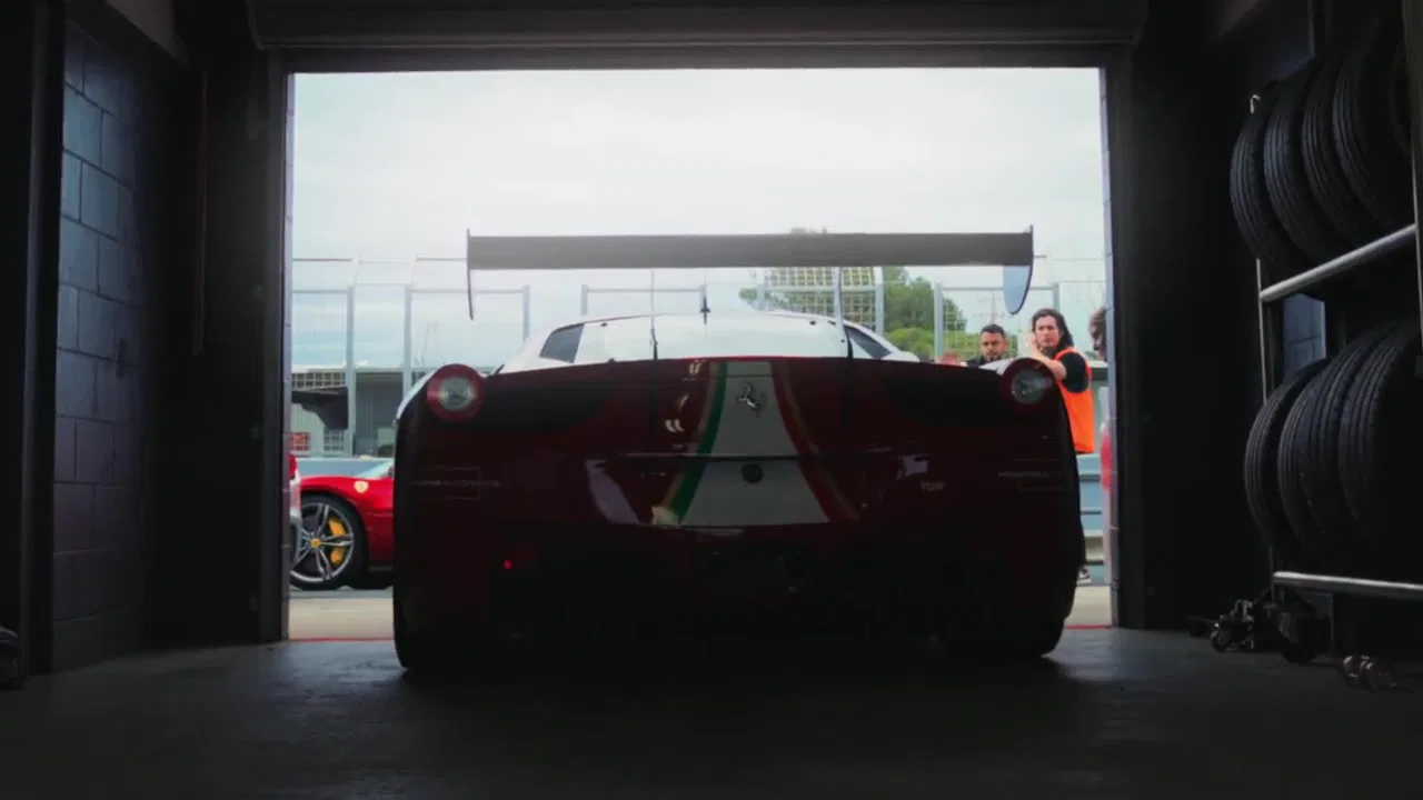 A Ferrari in a workshop doorway, a frame from the Ferrari Club Australia film