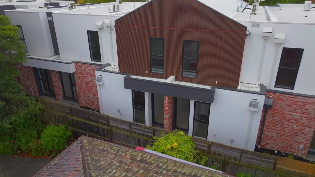 Aerial of new townhouses with brick and timber-clad facades, Harrison Street