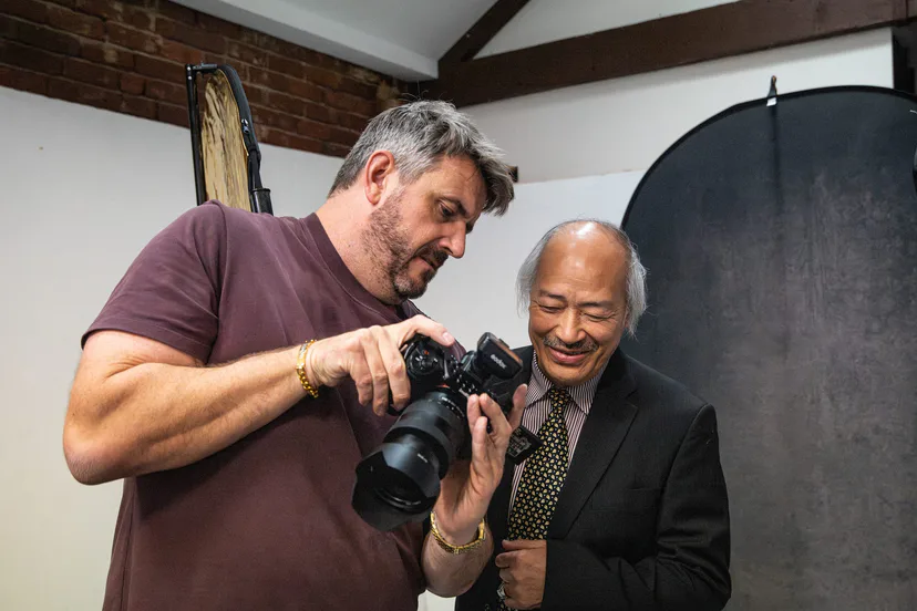 A photographer showing the back of his camera to a client between setups