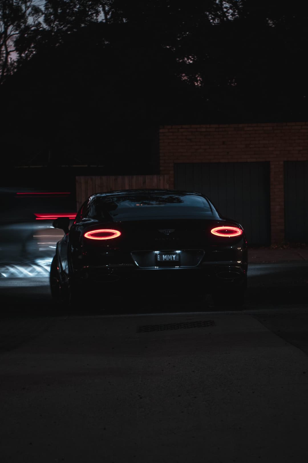 A moody night shot of a Bentley by Gabe