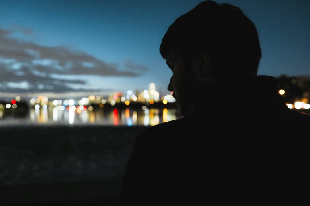 Gabe in silhouette against the Melbourne skyline at dusk