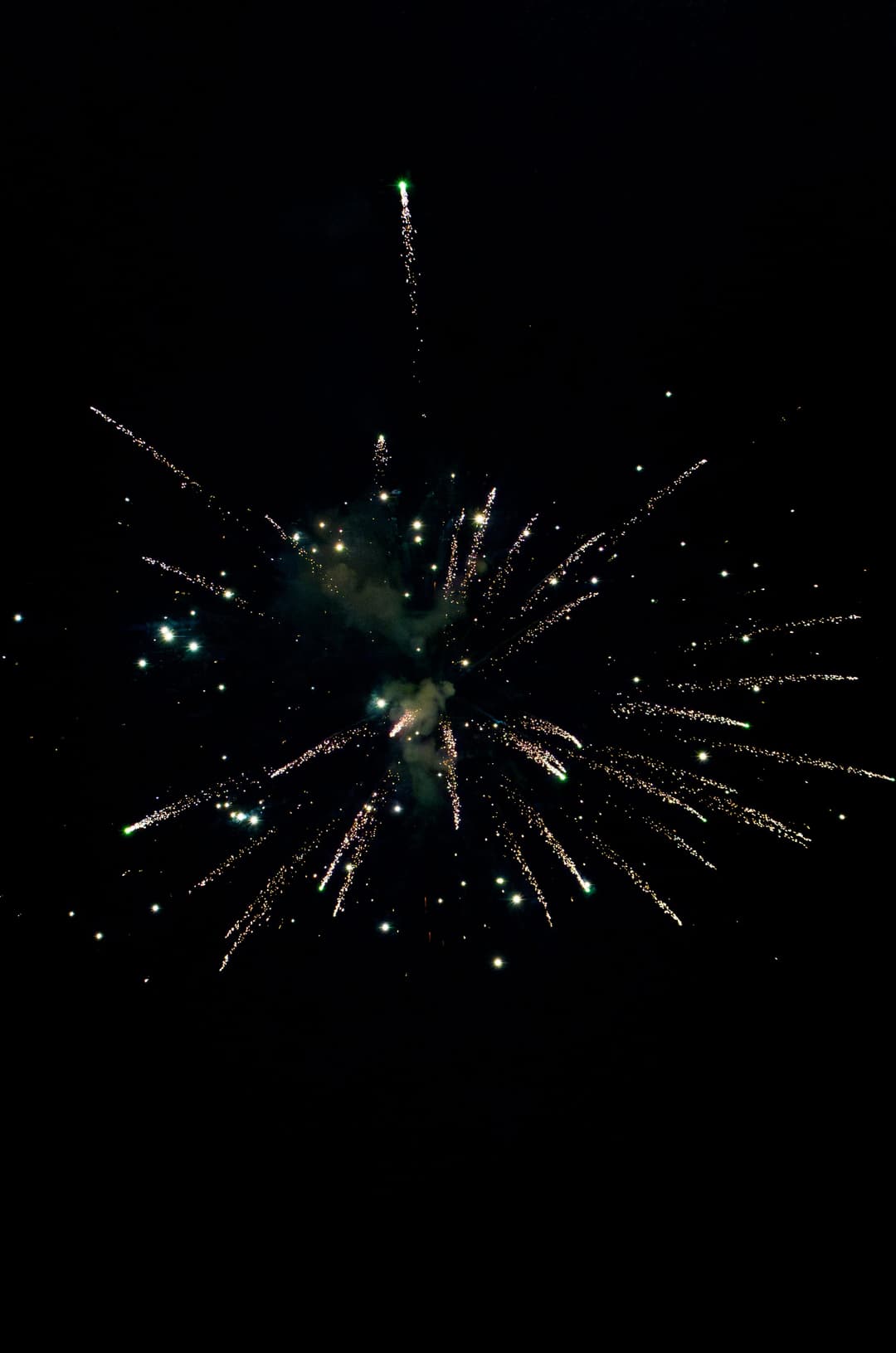 The tail of a firework burst, sparks scattering across a dark sky. Frame 1 of 6. Open it