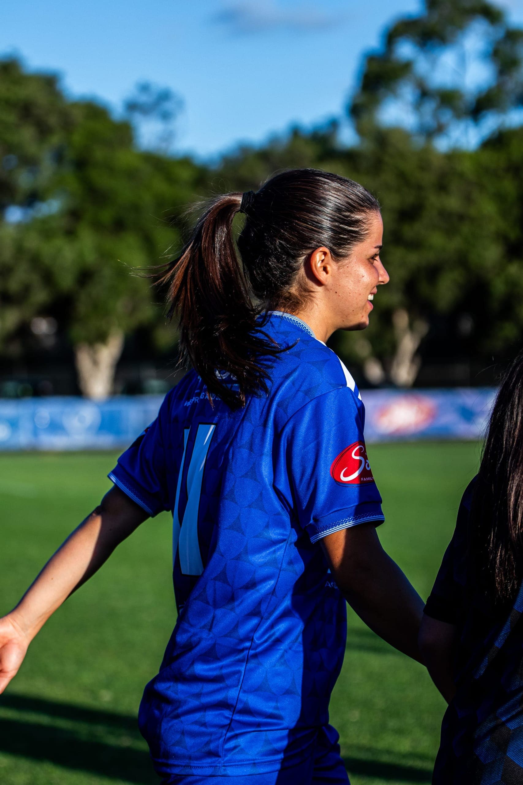 A Box Hill United player reaching out along the handshake line before kick-off