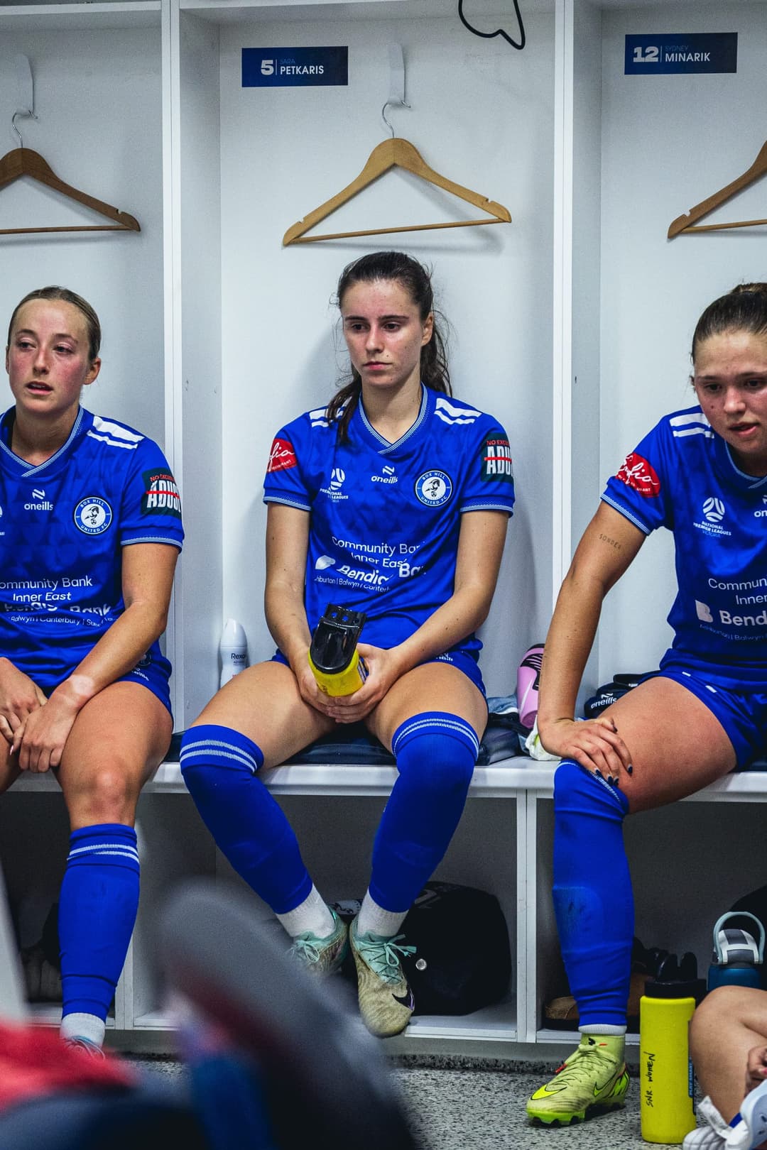 Box Hill United players sitting in the changerooms before a match