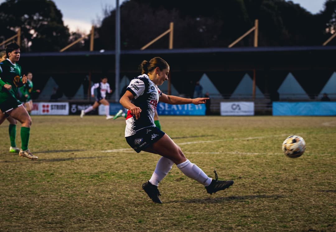 A Calder United player following through on a shot, the ball already away. Frame 4 of 12. Open it