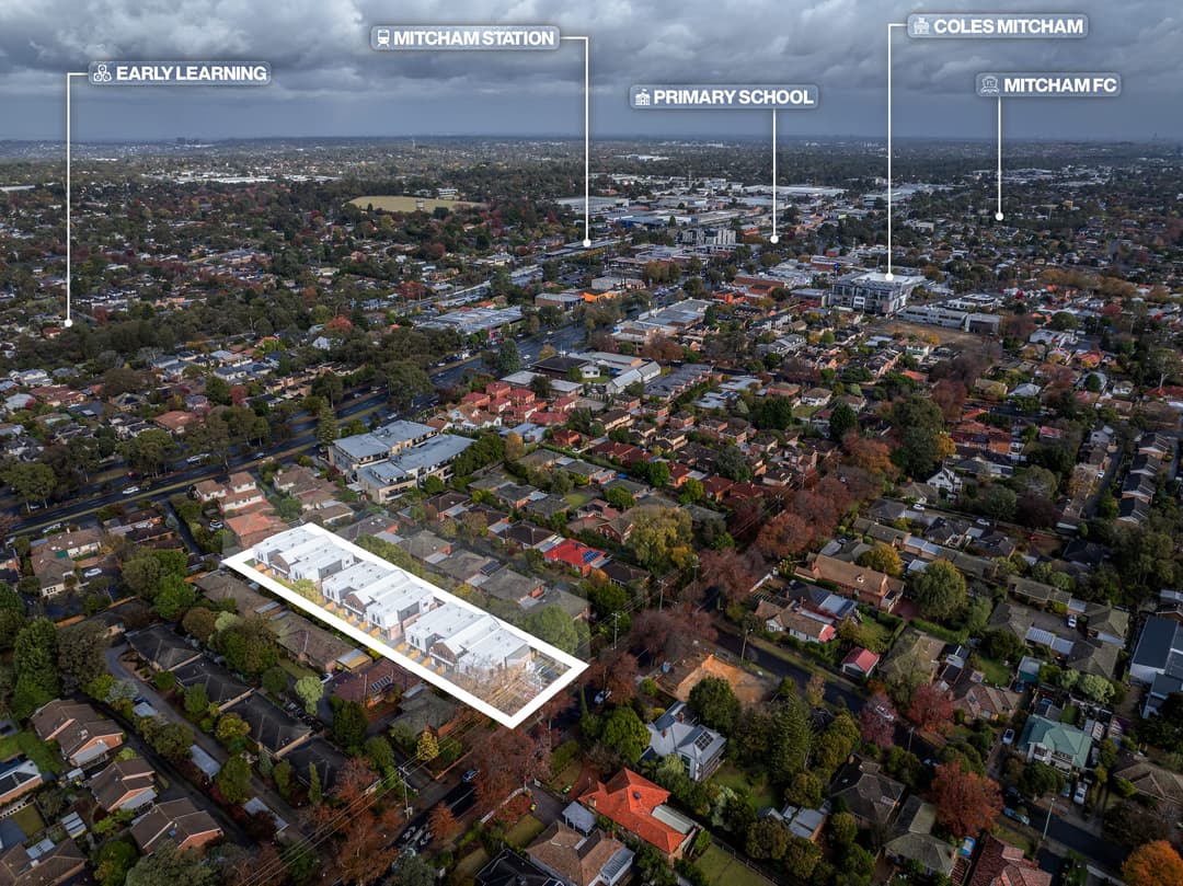 Drone view of a suburb with labels marking the station, shops, schools and a football club