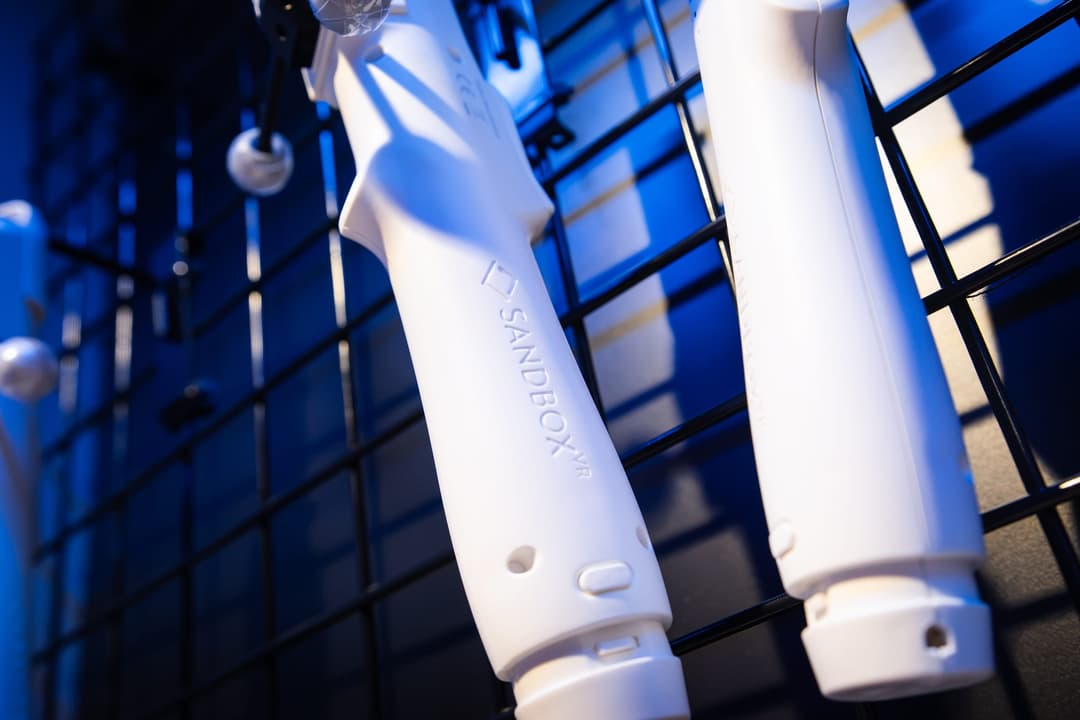 White VR blasters hanging on a rack