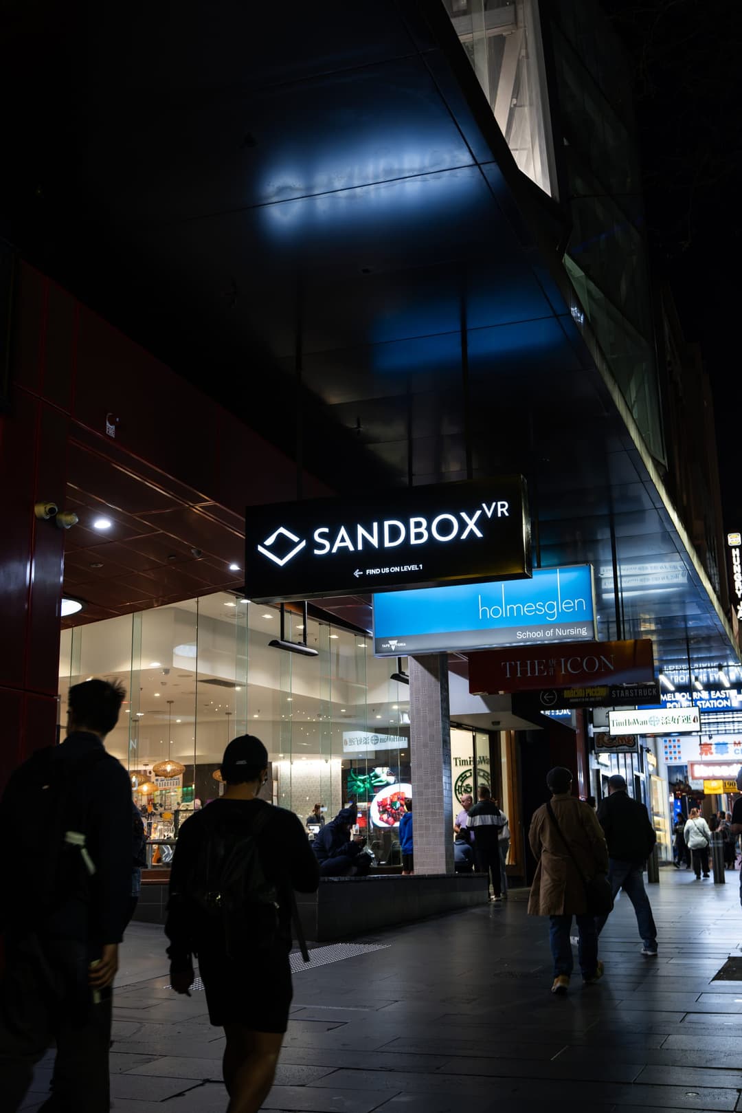 The Sandbox VR sign above a Melbourne arcade at night