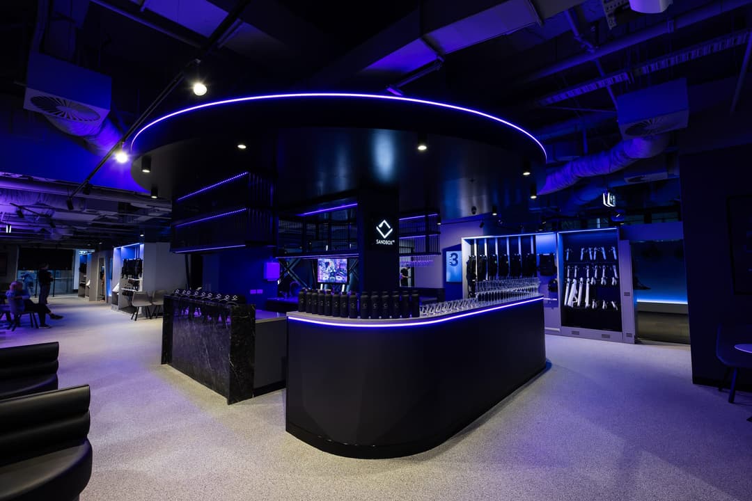 The Sandbox VR lounge and bar under a ring of blue light