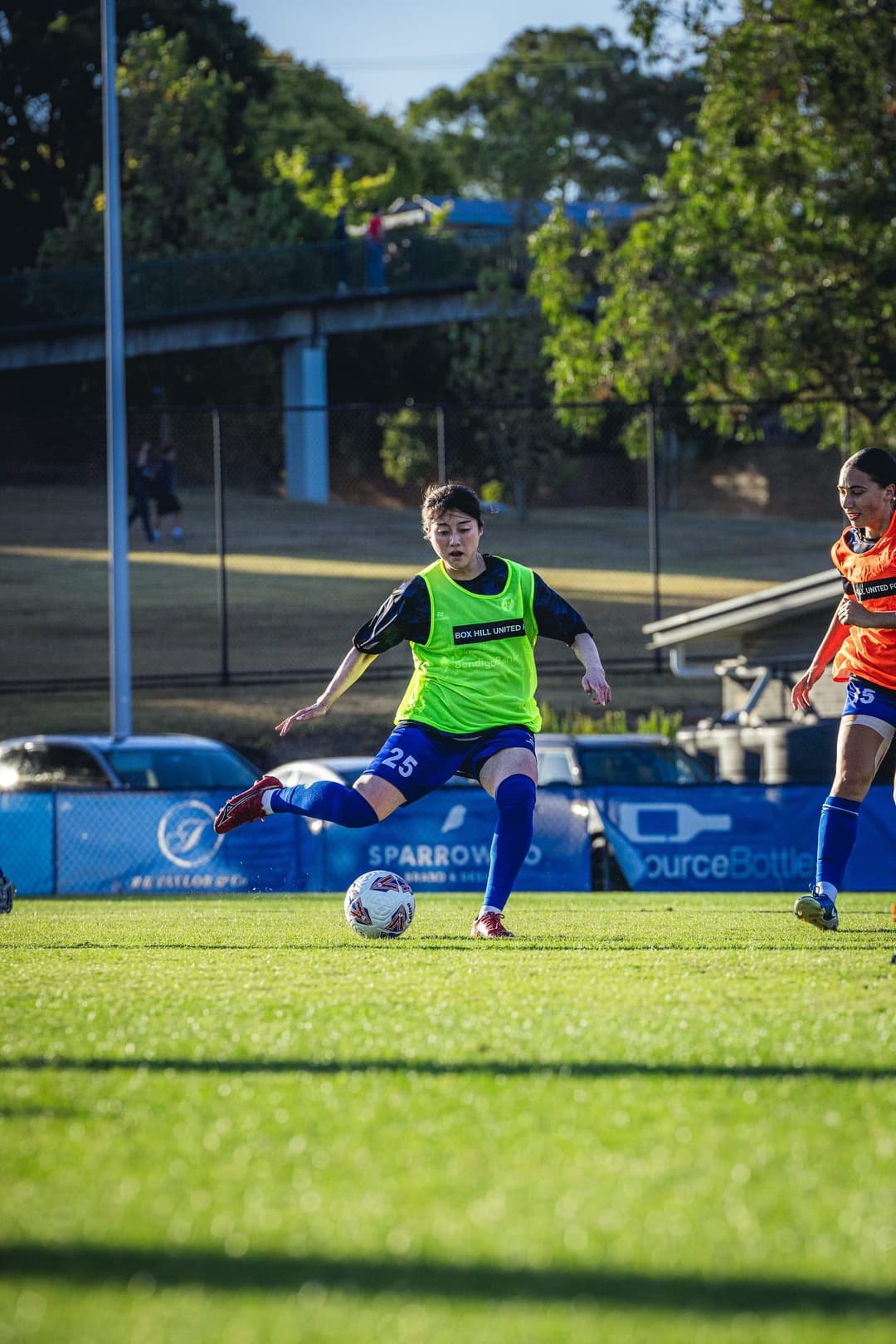 Two Box Hill United players working a passing drill in the pre-match warm-up