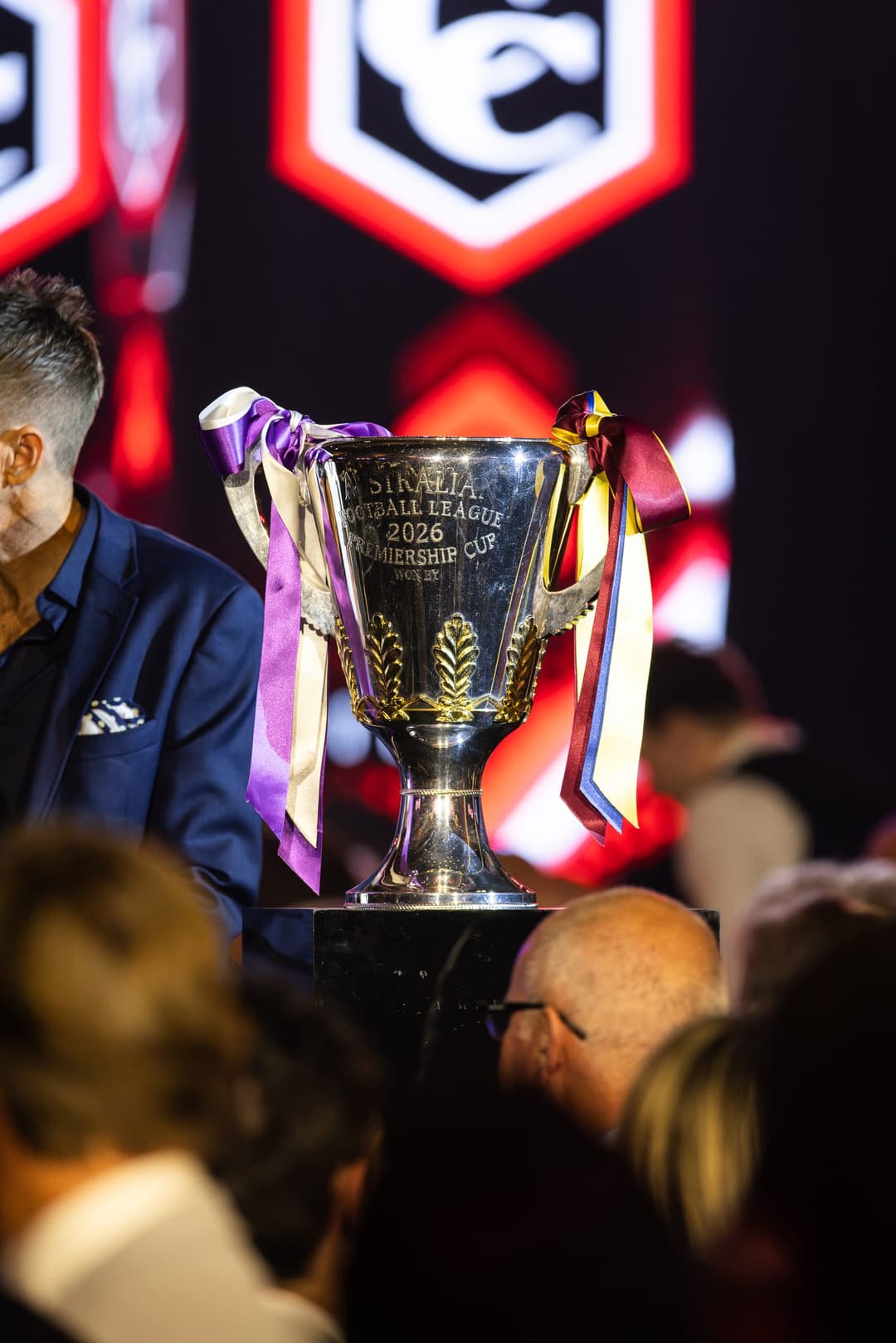 The premiership cup on stage with guests gathered around it