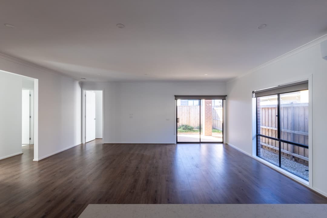 Empty open-plan living room with sliding doors onto the garden